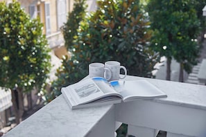 A marble table with a book, two mugs, and a magazine. - Casa Maggie (Albenga)