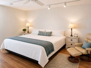 A bedroom with a bed, bedside tables, lamps, a chair, and a ceiling fan. - 2 bedroom 2 bath Luxury Bayfront condo on Longboat Key (Longboat Key)