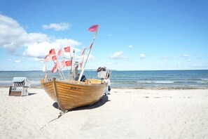 A wooden boat with the number BIN-11 on a sandy beach. - Holiday apartment in Binz with swimming pool (Binz)