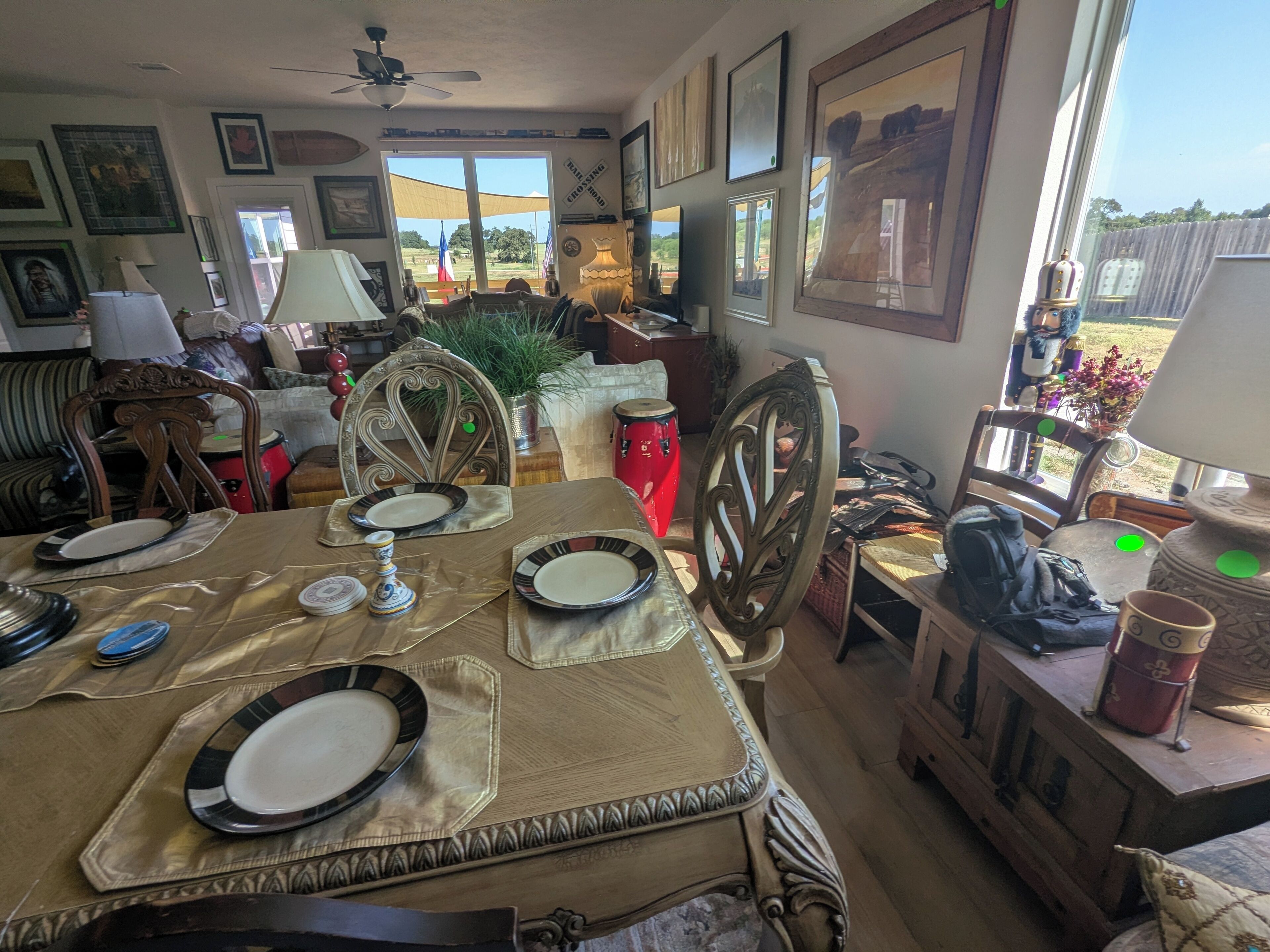 A dining area with a table set for four, chairs, and a view of the outdoors.