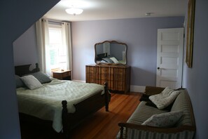 A bedroom with a bed, dresser, mirror, and a sofa. - Large 14bed Family Retreat a Stroll to York Harbor Beach and Venues (York)