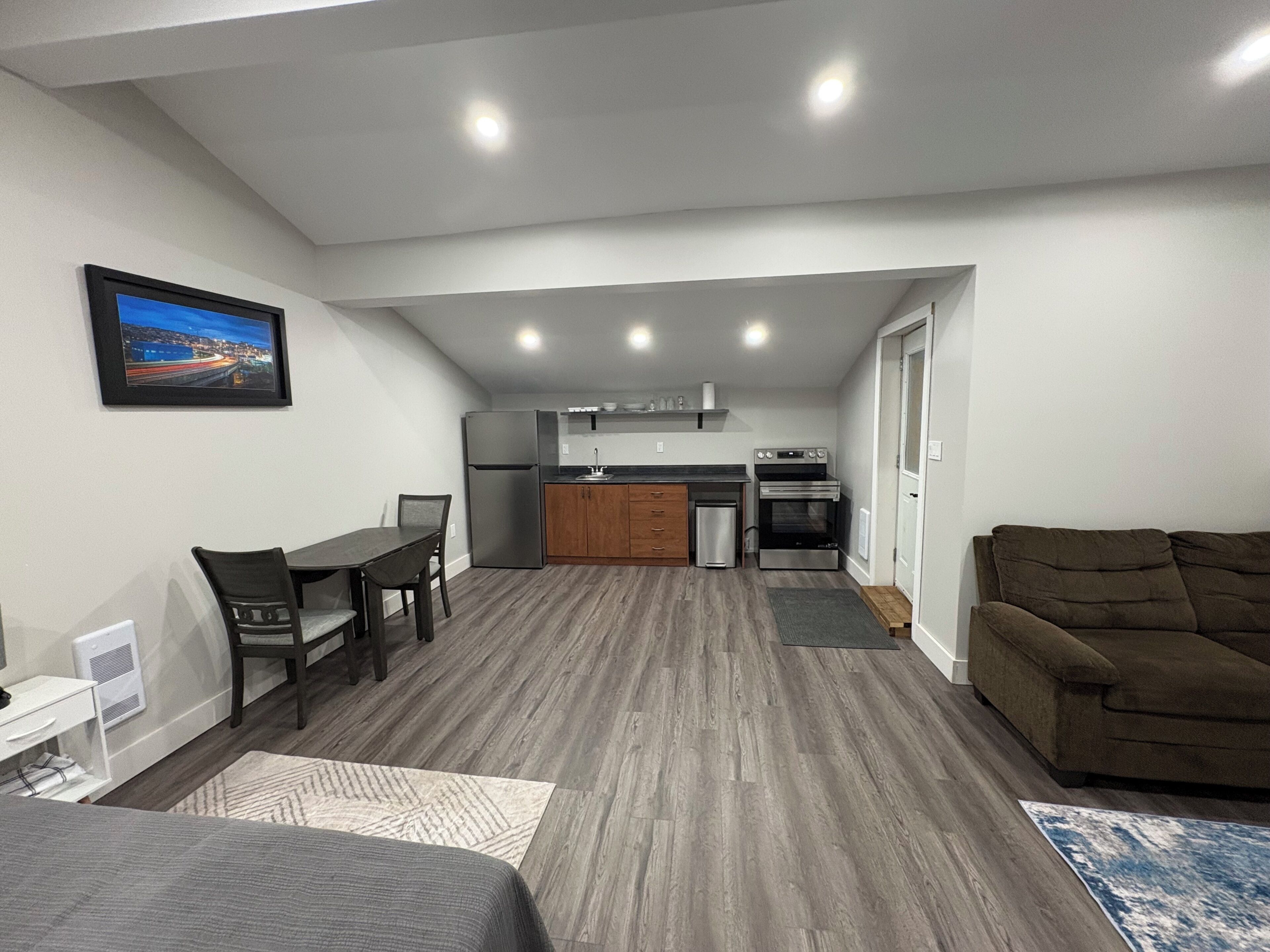 A compact living space with a kitchenette, a dining area, and a seating area.