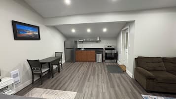 A compact living space with a kitchenette, a dining area, and a seating area.