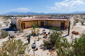 A desert-style building with a courtyard, surrounded by cacti and desert plants. - Cozy Vicky's Villa with Pool Access (San Felipe)