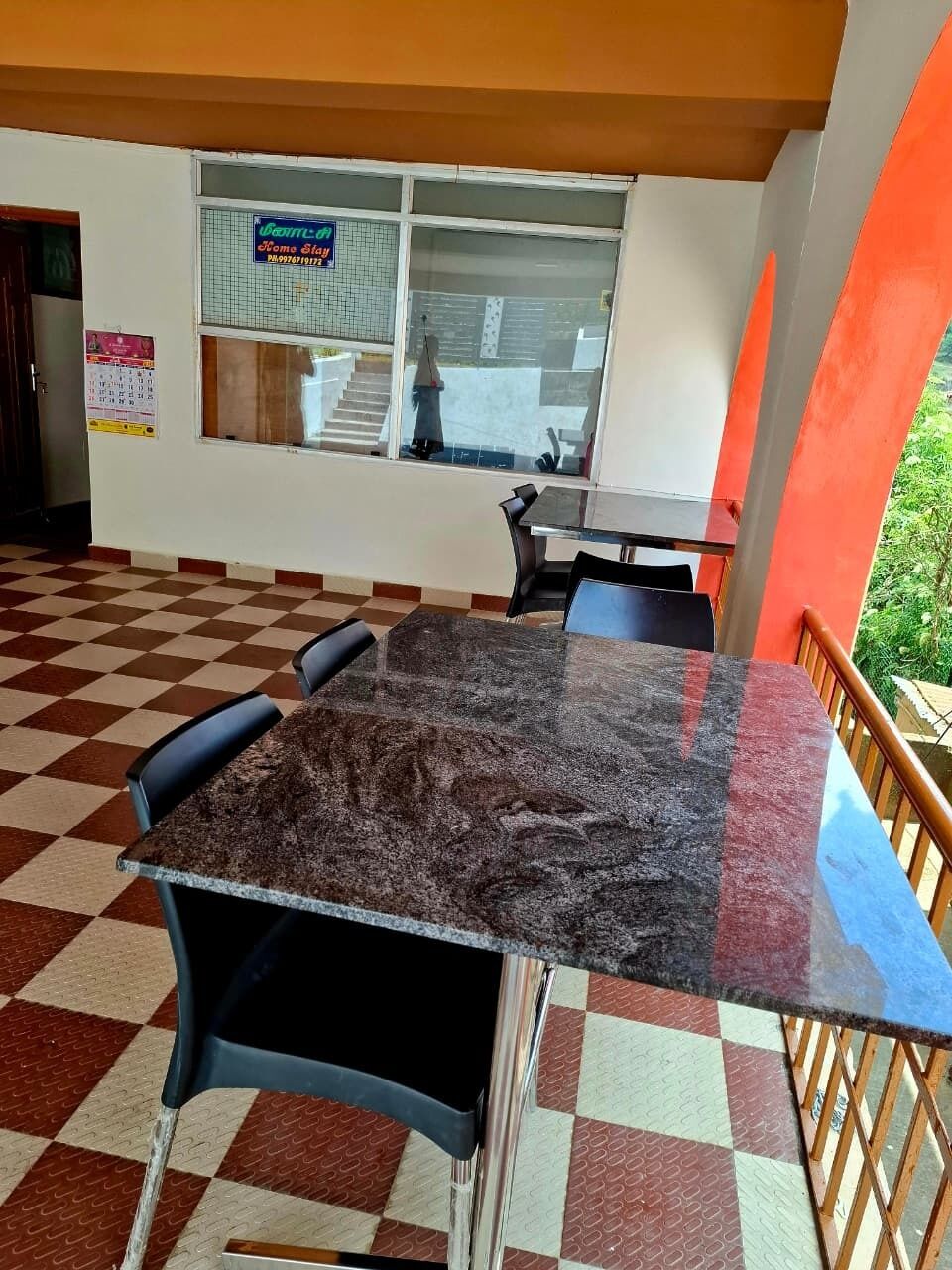 A checkered floor, a marble table, and a window with a sign.