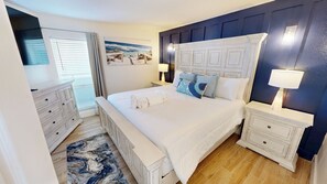 A bedroom with a large bed, two bedside tables, a dresser, and a painting on the wall. - Spacious Islander Beach Resort 506 - sleeps 10 with washer dryer (Fort Walton Beach)