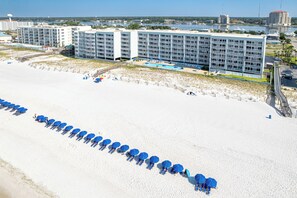 A beachfront hotel with multiple floors, a pool, and a beach area with umbrellas. - Stunning Renovated & Spacious IBR 607 - sleeps 8 (Fort Walton Beach)