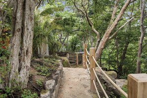 A forested pathway with wooden railings and a dirt path. - Exclusive 6BR Ocean-View Villa with detached apartment - Peninsula Papagayo (Peninsula Papagayo, Nacascolo)