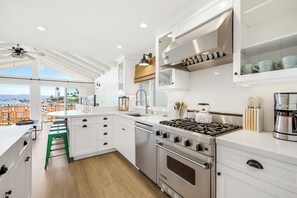 A modern kitchen with a large island, stainless steel appliances, and a view of the beach. - Great 4 Families, Walk 2 Beach and Bay W/Parking! (Newport Beach)