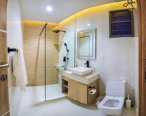 A modern bathroom with a shower, toilet, sink, and vanity. - Centurion Apartment (Abuja)