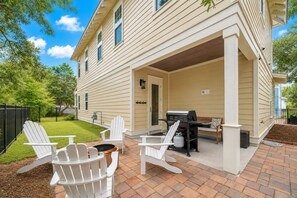 A house with a covered patio area featuring outdoor seating, a grill, and a hot tub. - Lovely Day 30a by Stay on 30a (Inlet Beach)