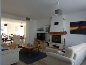 A living room with a fireplace, television, and seating area.