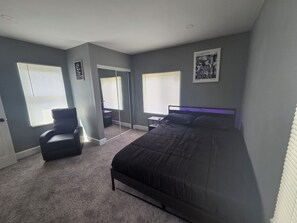 A bedroom with a bed, a chair, a desk, and a mirror. - Terrific 3-bedroom house with AC , one and a half bath in charming Zanesville oh (Zanesville)