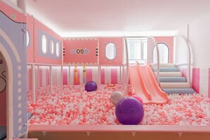 A children's play area with a ball pit, slides, and a climbing wall. - Azure Luxe Residence (Nairobi)