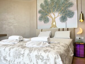 A neatly made bed with white linens and a floral-patterned bedspread. - 155 PRO - Stay Prime View Apartment (Paralimni)