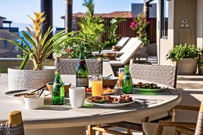A round table with breakfast items, two bottles of Perrier water, a bottle of Moet & Chandon champagne, and a potted plant. - PH5 in Punta Mita With 4 Bedrooms and 5 Bathrooms (Punta de Mita)