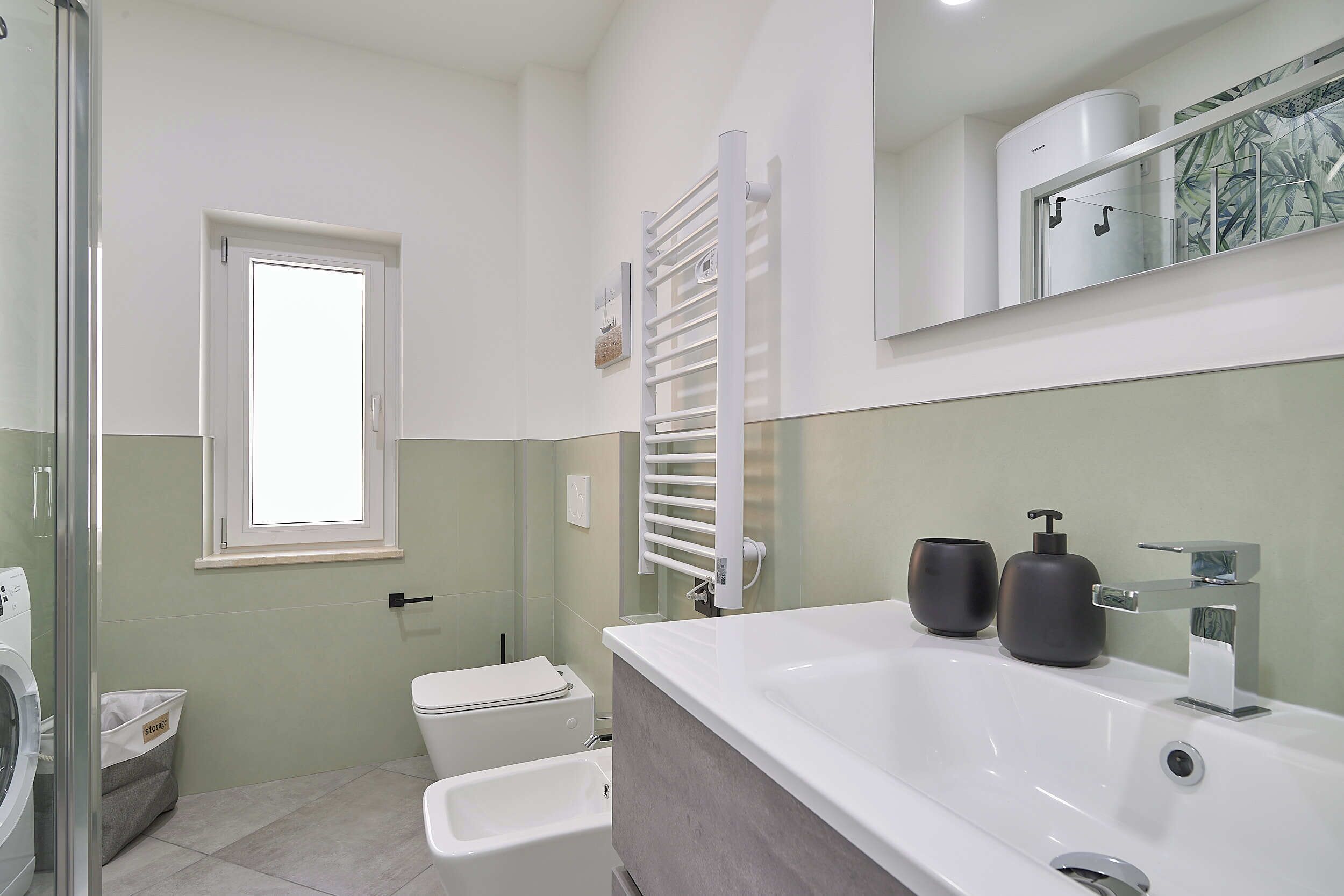 A modern bathroom with a large bathtub, a toilet, and a shower area.