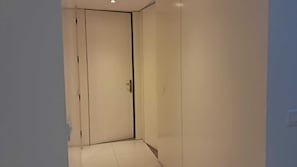 A narrow hallway with a closed door at the end.