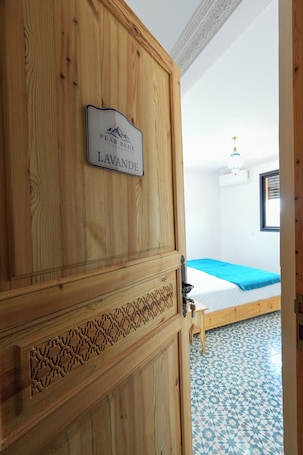 A wooden door with a sign reading 'PEAK BLUE ATLAS LAVANDE.'