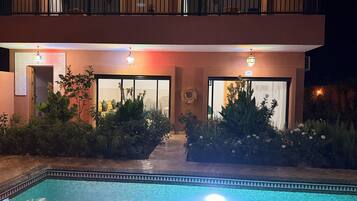 A two-story building with a swimming pool in front.
