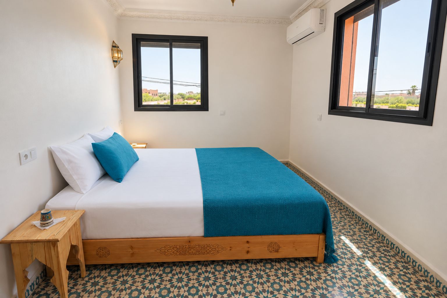 A bedroom with a bed, a nightstand, a window, and patterned flooring.