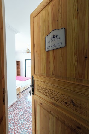 A wooden door with a sign reading 'Peak Blue Atlas Cannelle.' - Atlas Peak Blue (Sidi Abdallah Ghiat)