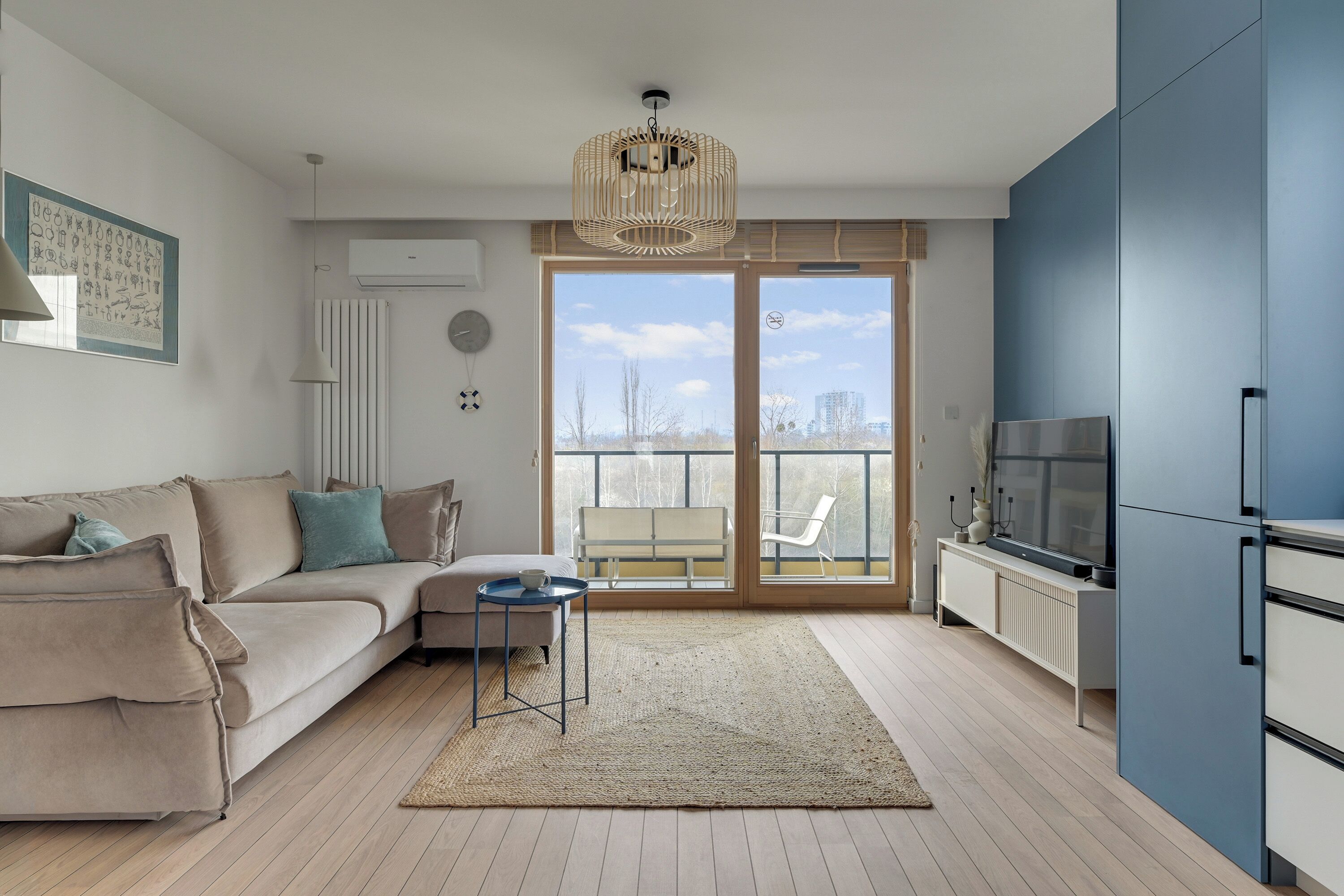 A modern living room with a sofa, a coffee table, and a TV.