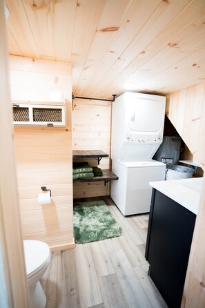 A compact kitchen with a washing machine, a sink, and a small countertop. - Perfect Couples Retreat - firepit (Carlisle County)