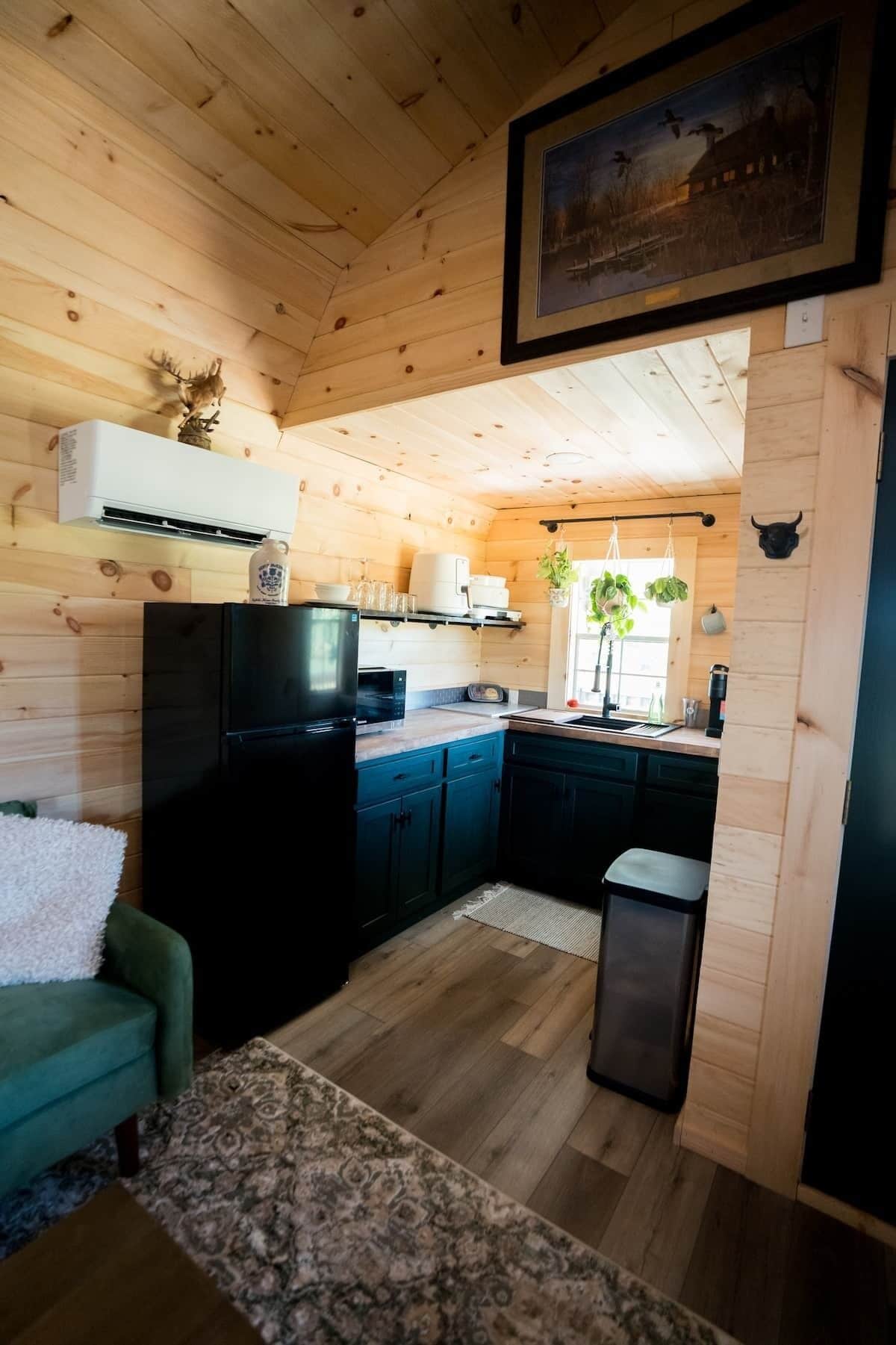 A wooden interior with a kitchen, a dining area, and a living room.