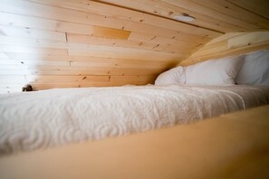 A room with a wooden ceiling and a bed with white bedding. - Perfect Couples Retreat - firepit (Carlisle County)