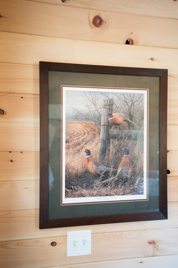 A framed wildlife photograph on a wooden wall.