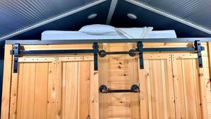 Una porta de fusta amb un tirador metàl·lic i un objecte blanc a la part superior.