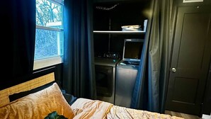 A bedroom with a bed, a window, a wardrobe, and a desk. - Hot Tub + Pet Friendly / Perfect for travel ball (Paducah)