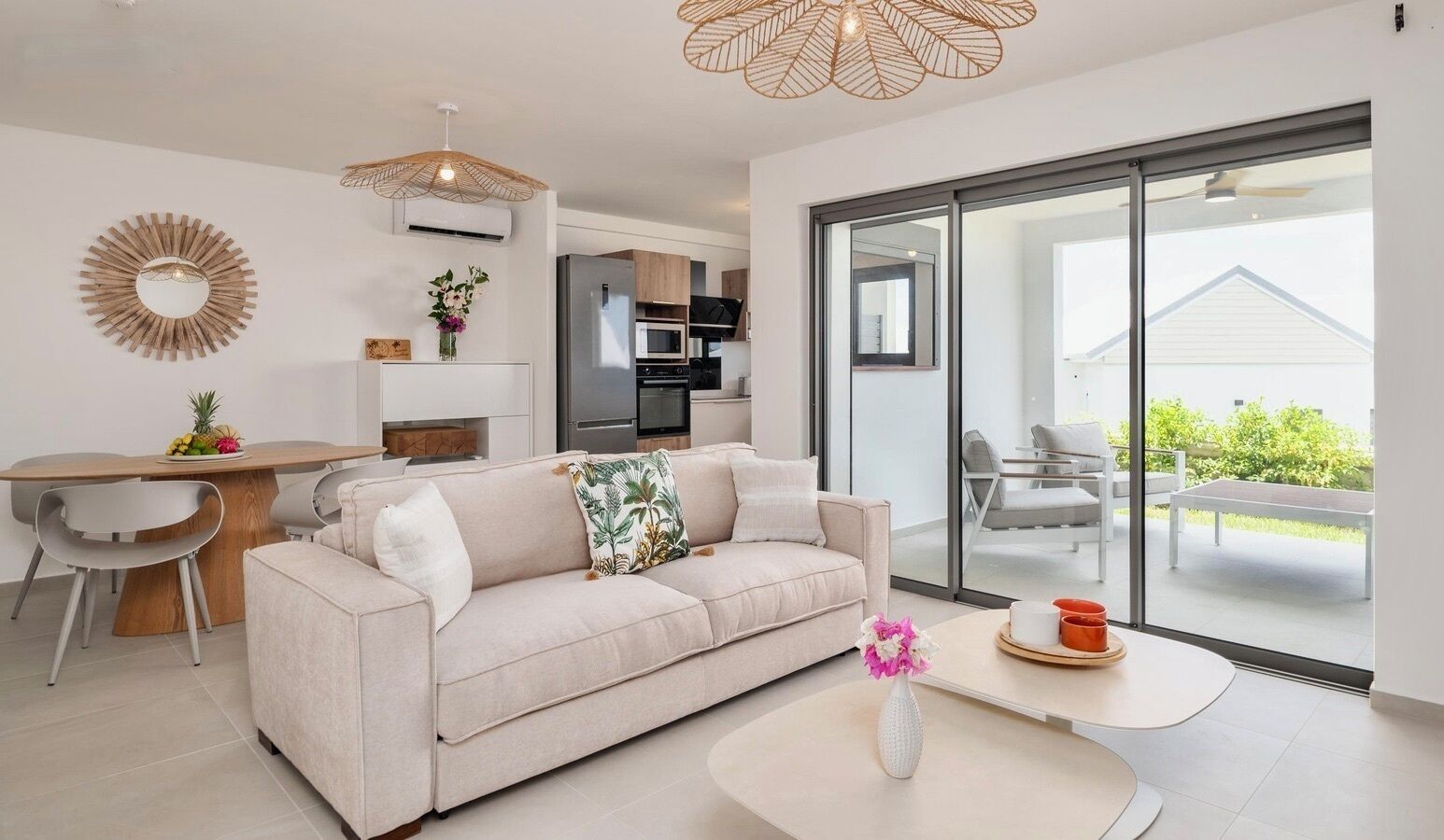 A modern living room with a sofa, a dining table, and a large window.
