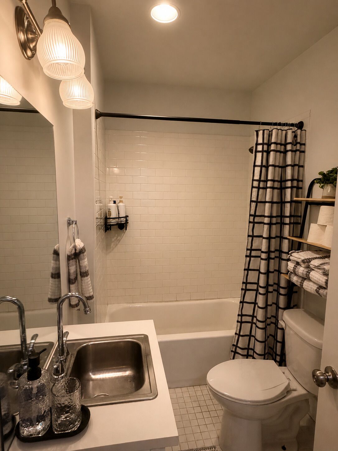 A bathroom with a bathtub, toilet, and sink.