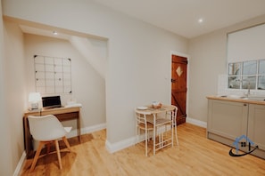 A compact kitchen with a wooden countertop, a white sink, and a window above the sink. - Dale House, sleeps 7, central, parking x2, garden (Rothwell)
