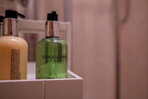 Two bottles of toiletry products in a white box.