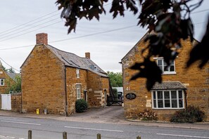 A traditional stone building with a sign indicating 'The Old Place.'