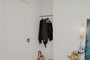 A white door with a coat rack holding several coats. - Apt 5 - 3 Bed 2 bathroom sleeps 5 parking wifi (Desborough)