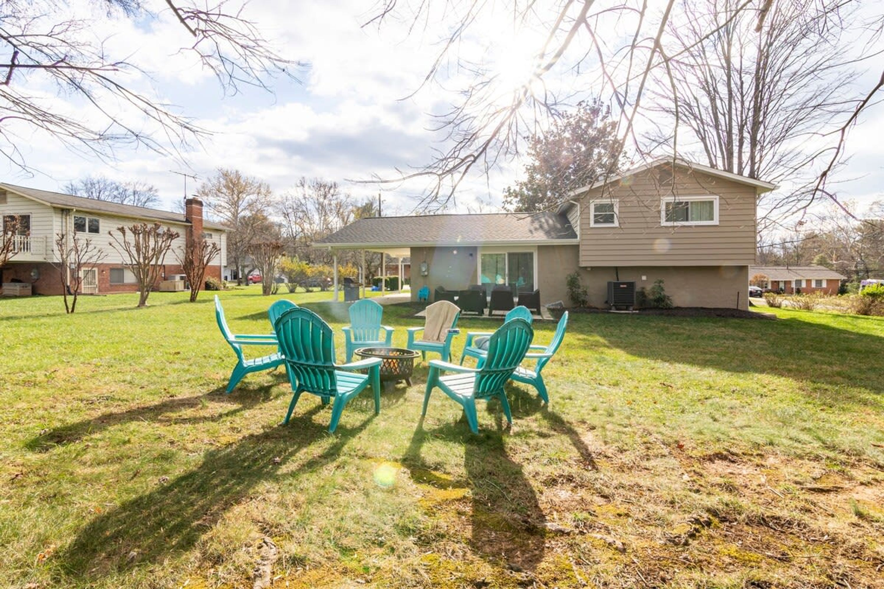 A residential property with a backyard patio area featuring outdoor seating.