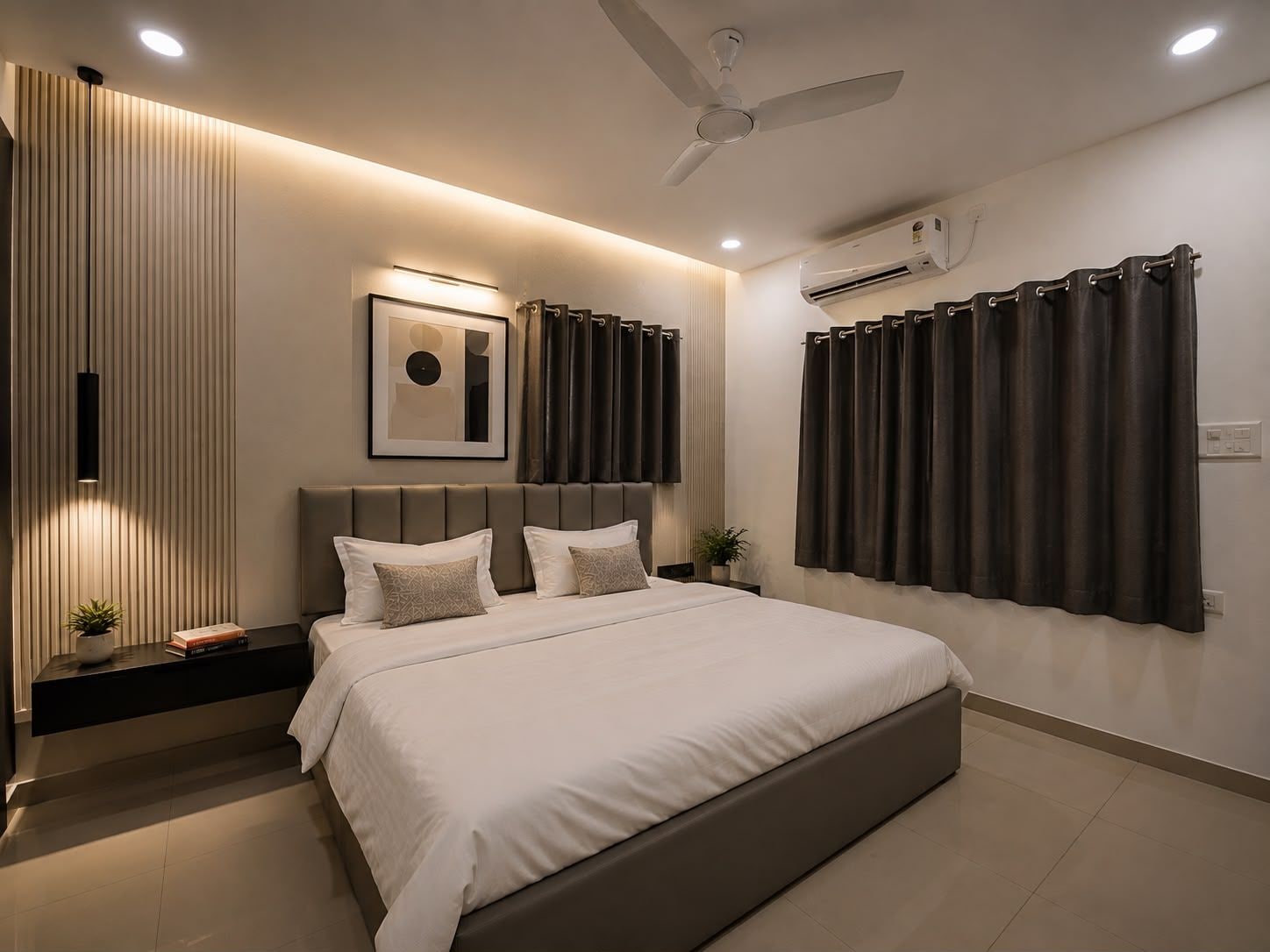 A modern bedroom with a bed, bedside tables, a ceiling fan, and an air conditioning unit.