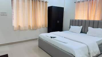 A bedroom with a bed, a wardrobe, and curtains.