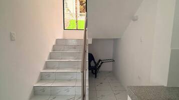 A staircase with marble steps leading to a landing.
