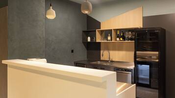A modern kitchen with a built-in refrigerator, a sink, and a wine rack.