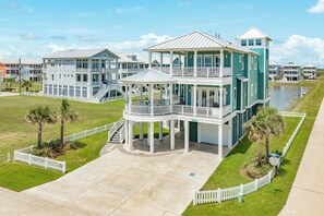 A multi-story beachfront property with a covered patio, multiple balconies, and a pool. - 2nd Row w/ Gulf Views in Beachside Village - All Suite Bedrooms+ Elevator (Galveston)
