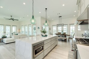 A spacious kitchen with a large island, modern appliances, and pendant lighting. - 2nd Row w/ Gulf Views in Beachside Village - All Suite Bedrooms+ Elevator (Galveston)