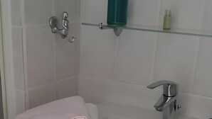 A bathroom with a white sink, two towel racks, a mirror, and a glass shelf with toiletries. - Bed and Breakfast 'Domaine Des Mouillères - Julie' with Shared Terrace, Shared Garden and Wi-Fi (Saint-Georges-la-Pouge)
