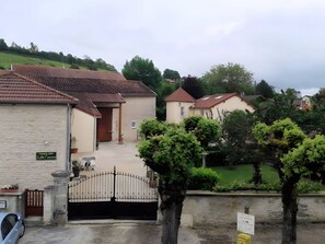 Un quartier résidentiel avec des maisons, une entrée sécurisée et un panneau indiquant la présence d’un hôtel.