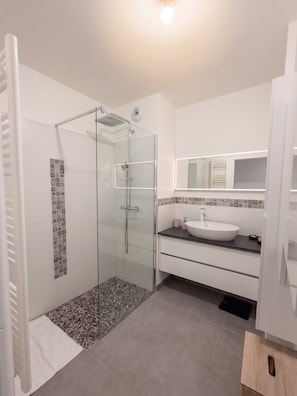 A modern bathroom with a glass-enclosed shower, a white sink, and a tiled backsplash. - L Azulejo - Work From Home Ideal - Mobility Lease Rental - 4pax (Toulouse)