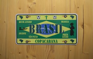 A wall-mounted license plate with the word 'BRASIL' and a map of Brazil.